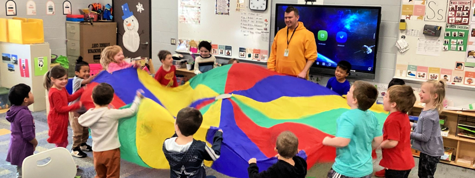 Preschool students participating in parachute activity site