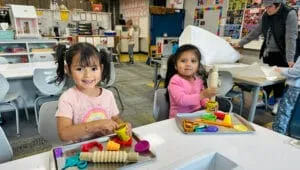 Preschool students creating with play doh homepage