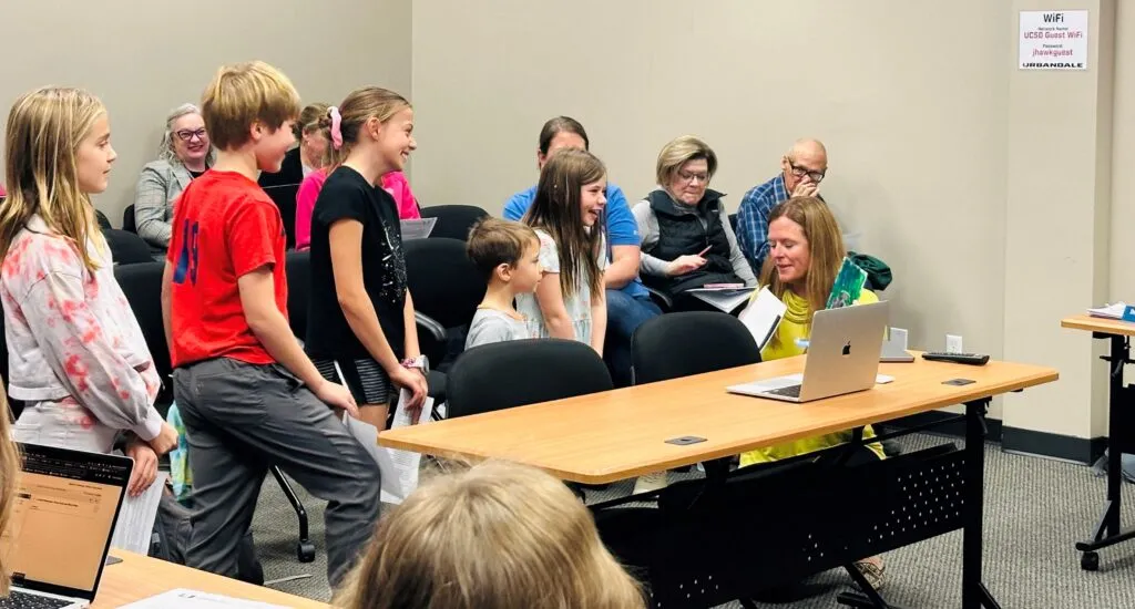 Elementary students at a school board meeting with Principal Wilson
