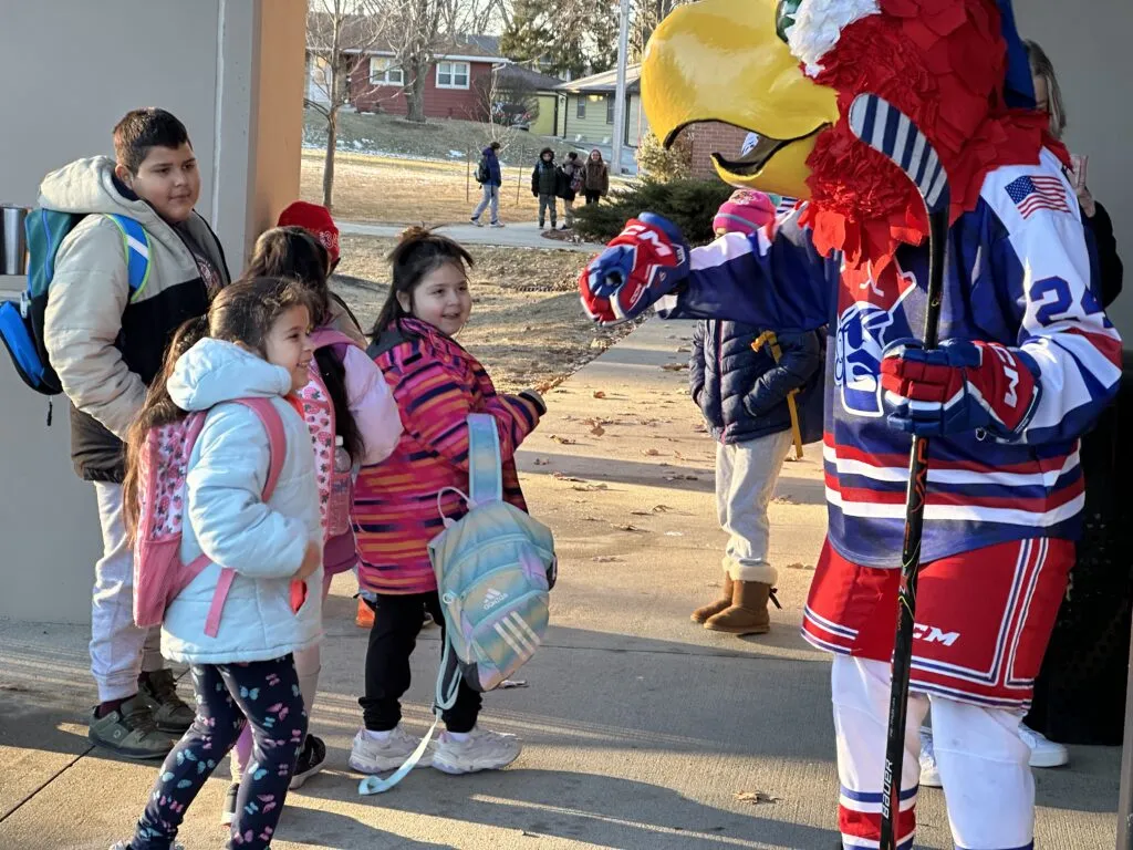Des Moines Buccaneers mascot greets elementary students.