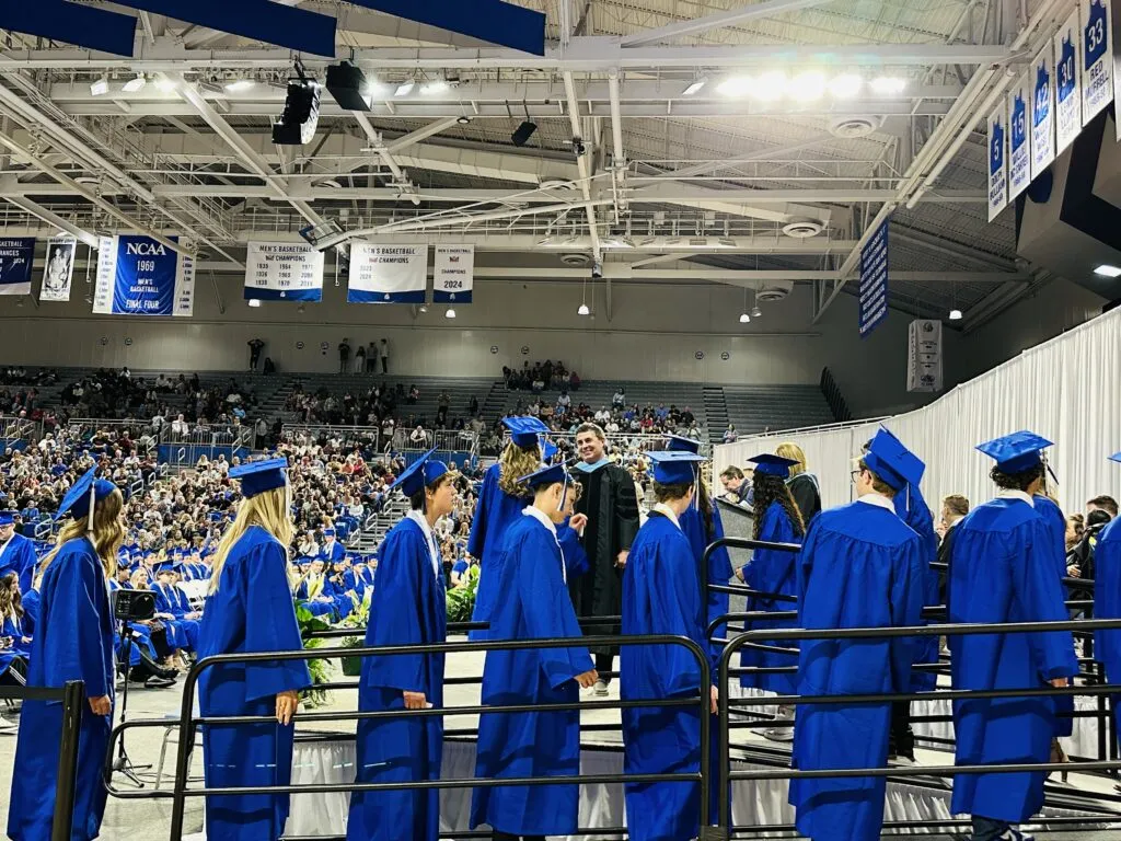 UHS Graduation Seniors entering stage to receive diploma Knapp Center