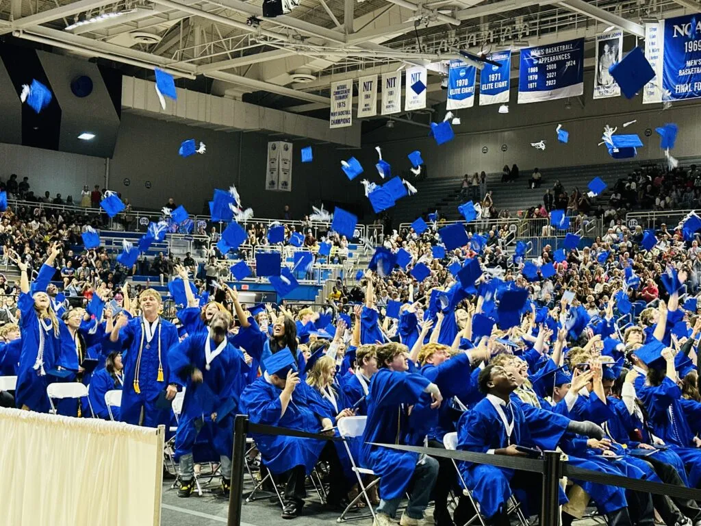 UHS Graduation Seniors tossing caps at conclusion of ceremony at Knapp Center
